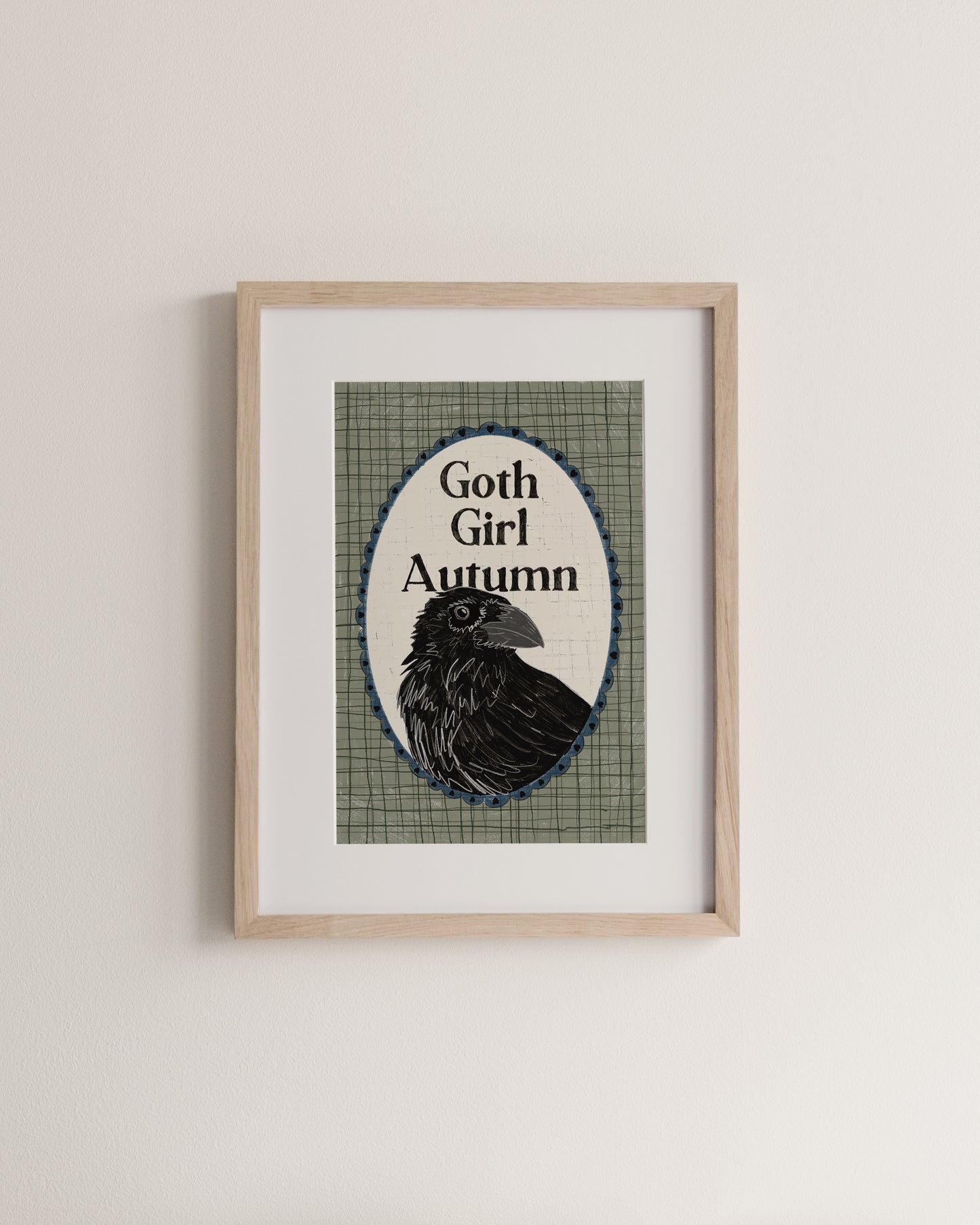 Framed artwork with a raven and 'Goth Girl Autumn' text on a plaid background.