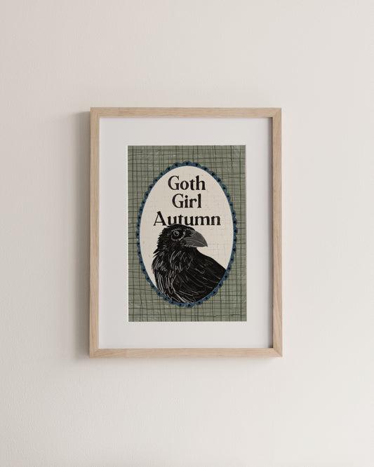 Framed artwork with a raven and 'Goth Girl Autumn' text on a plaid background.